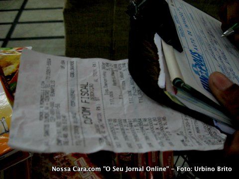 Cupom fiscal na m&atilde;o do inspetor sant&aacute;rio enquanto era lavrado o auto de infra&ccedil;&atilde;o