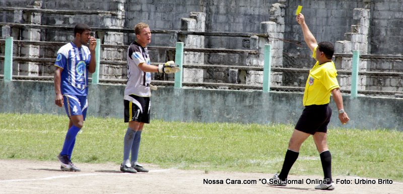 O &aacute;rbitro Juscelino aplica o cart&atilde;o amarelo ao jogador do Pequi Futebol Clube